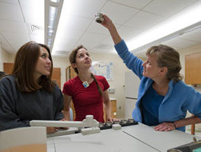 A teacher explaining an experiment to two students. Links to Gifts of Cash, Checks, and Credit Cards